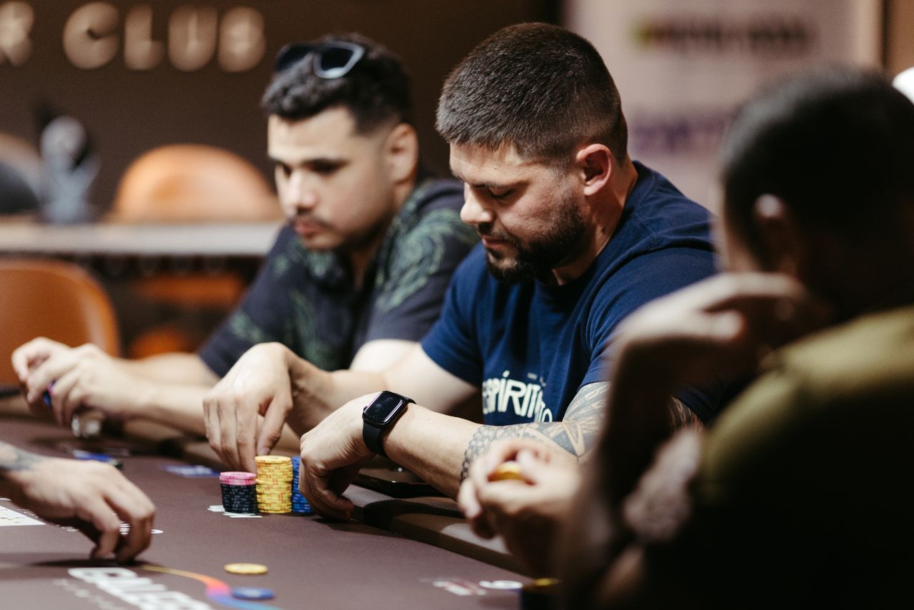 team-01 Players focused on a poker game at a casino table, showcasing intense strategies and concentration.