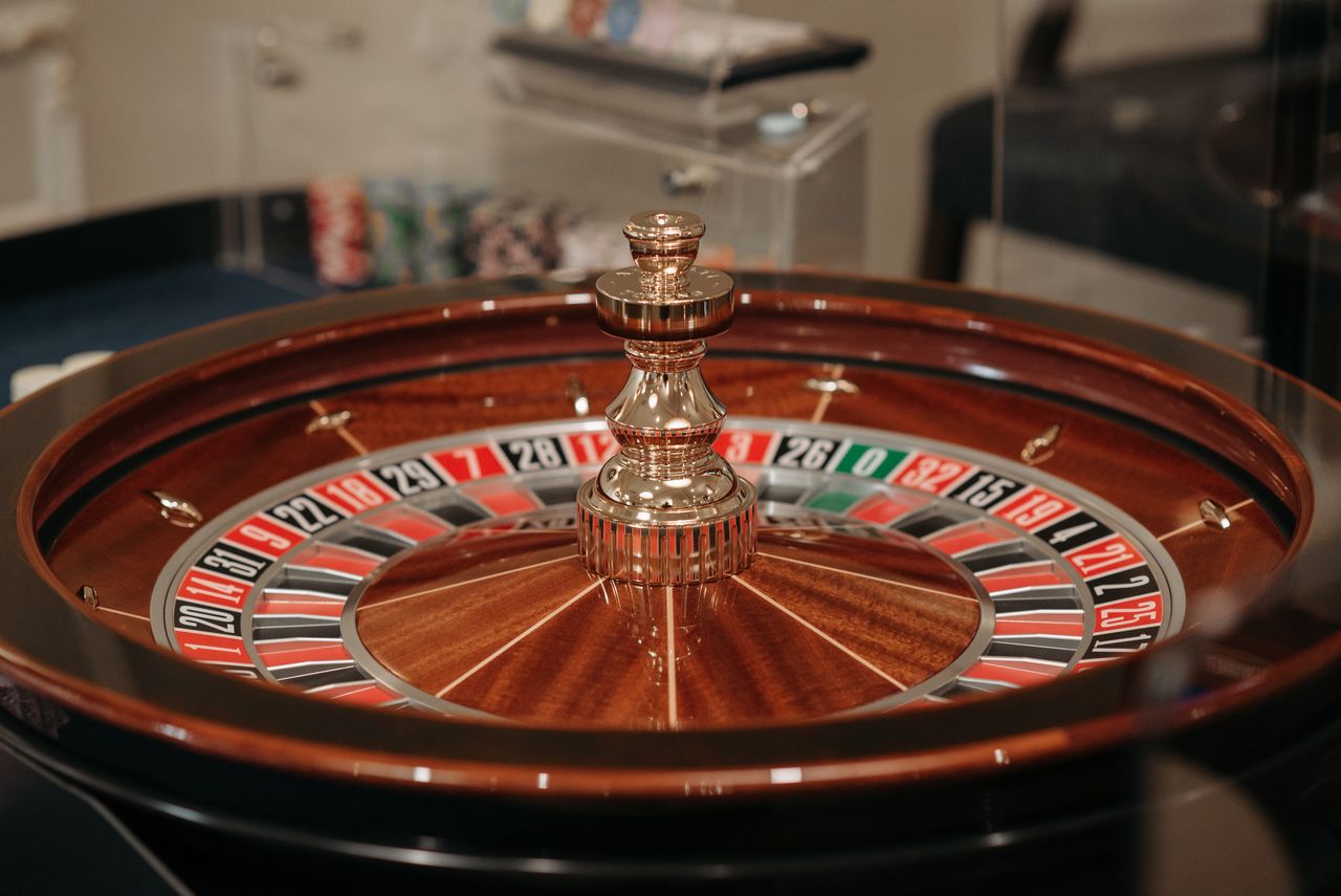 services-01 Close-up of a classic roulette wheel in a casino setting showcasing the elegant wooden design.